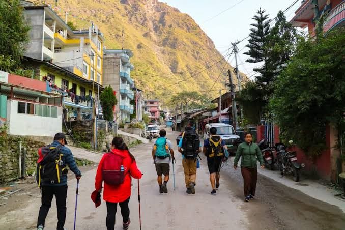 Trekkers walking through the village of Syabrubesi